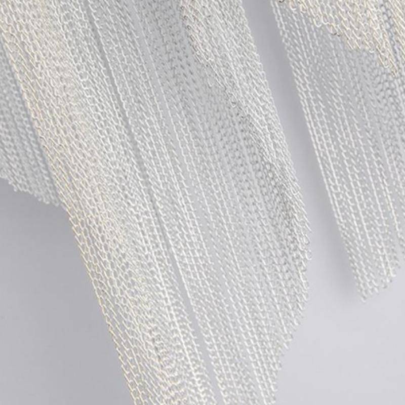 Detail of the Cadena sconce's fine aluminum chain tassels catching warm light, from Morsale.com.