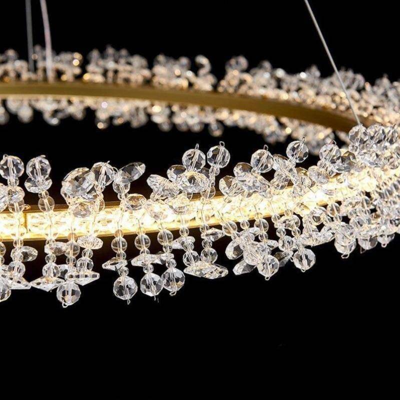 Detail of brushed gold ring and clear crystal strands