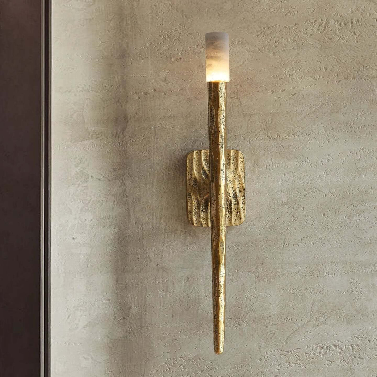 Detail of the forged brass arm on the Valen sconce