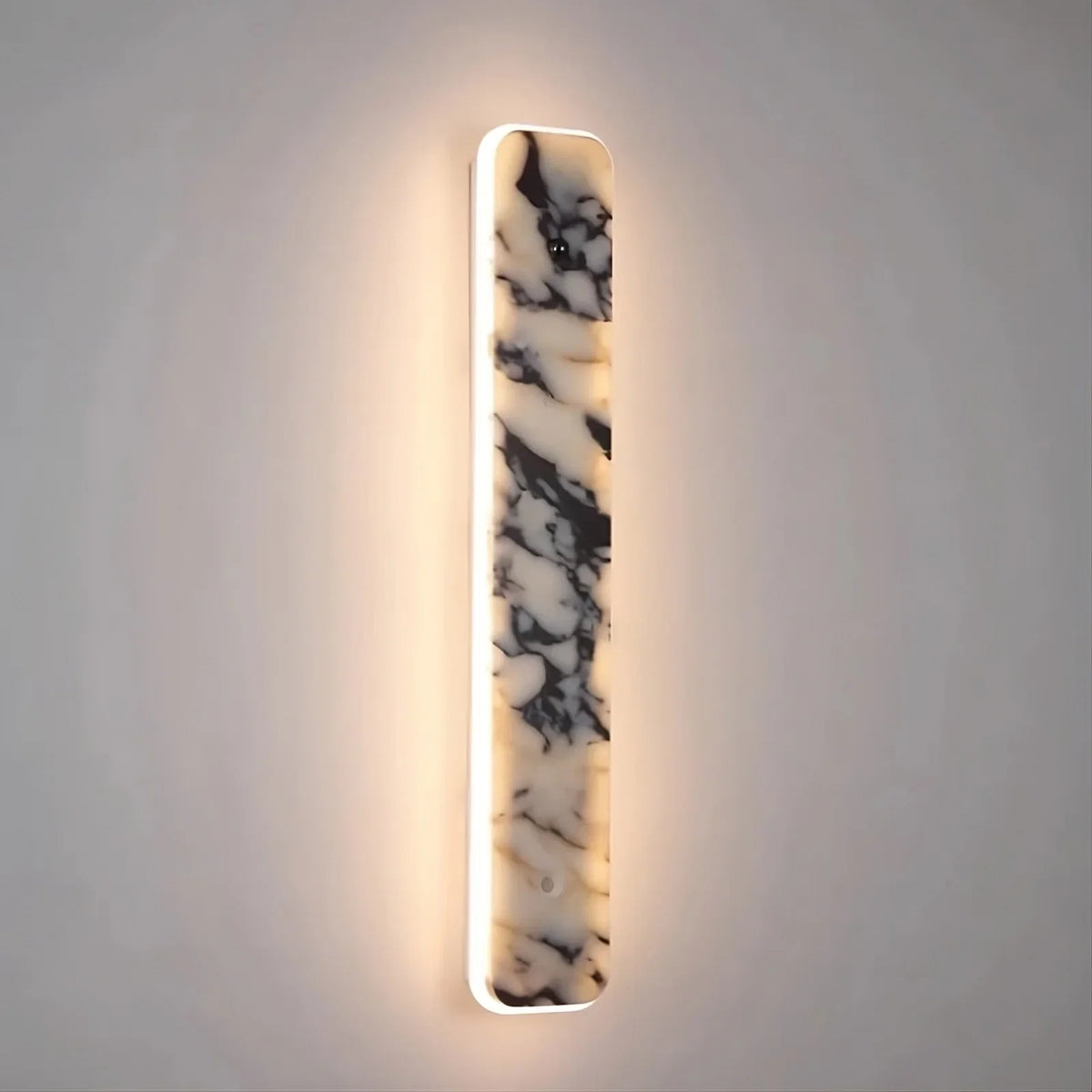 Warner marble LED wall sconce mounted on a wall