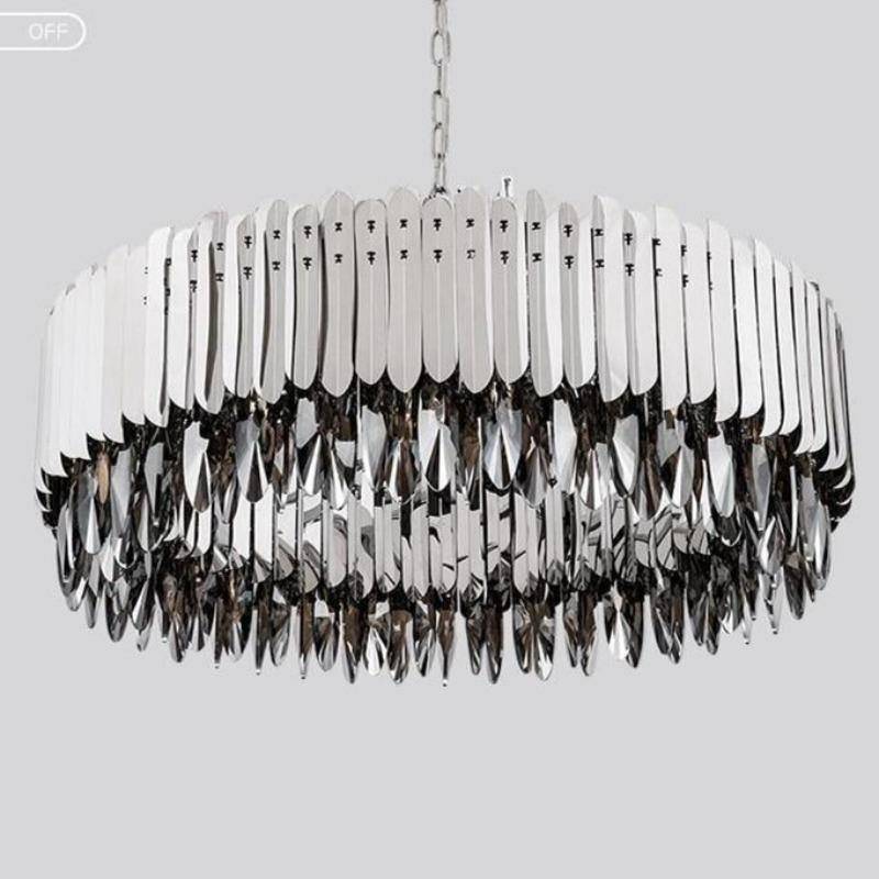 The Legance smokey crystal chandelier from Morsale.com casting warm layered light, tinted crystal on a steel frame.