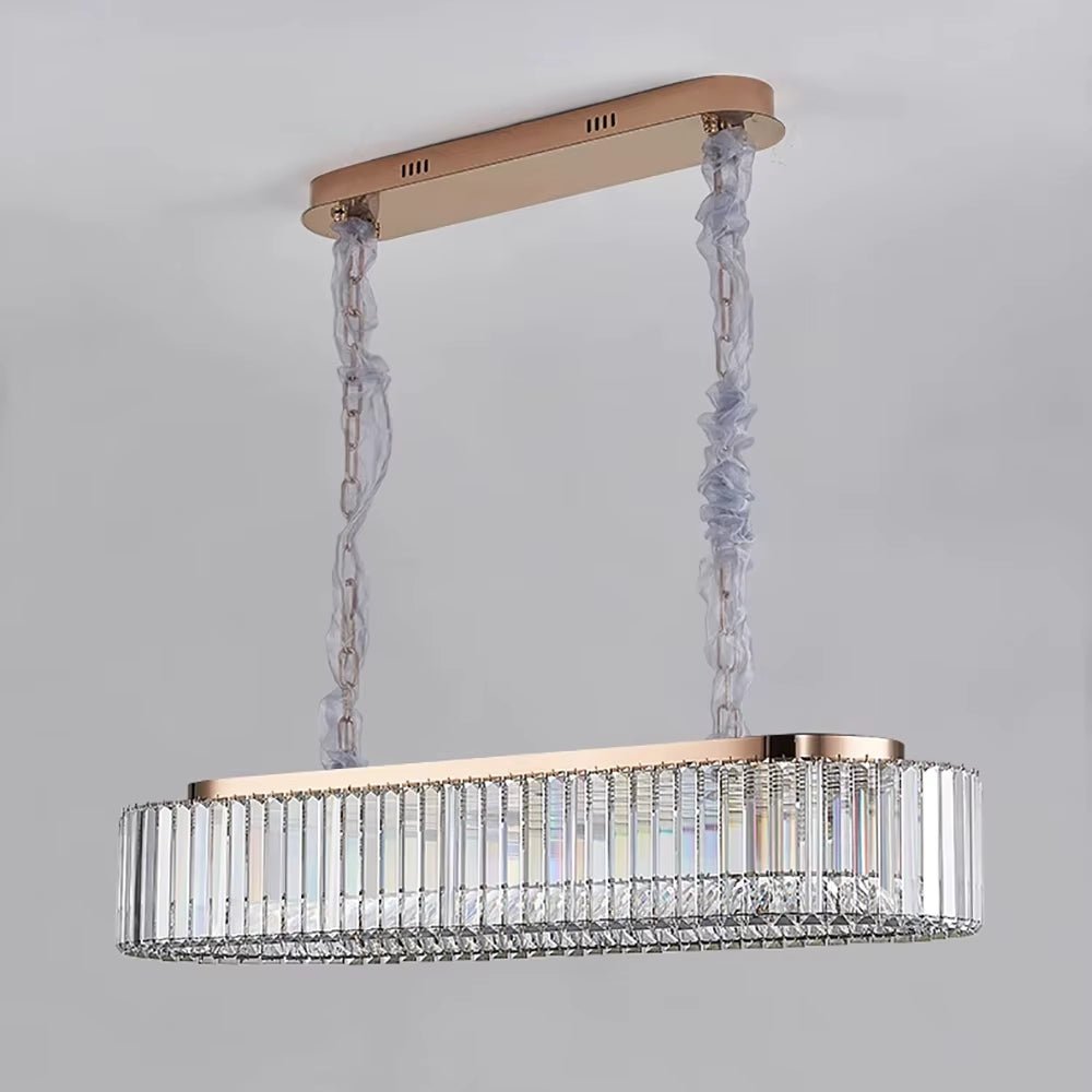 Gio crystal dining chandelier illuminated above a long dining table
