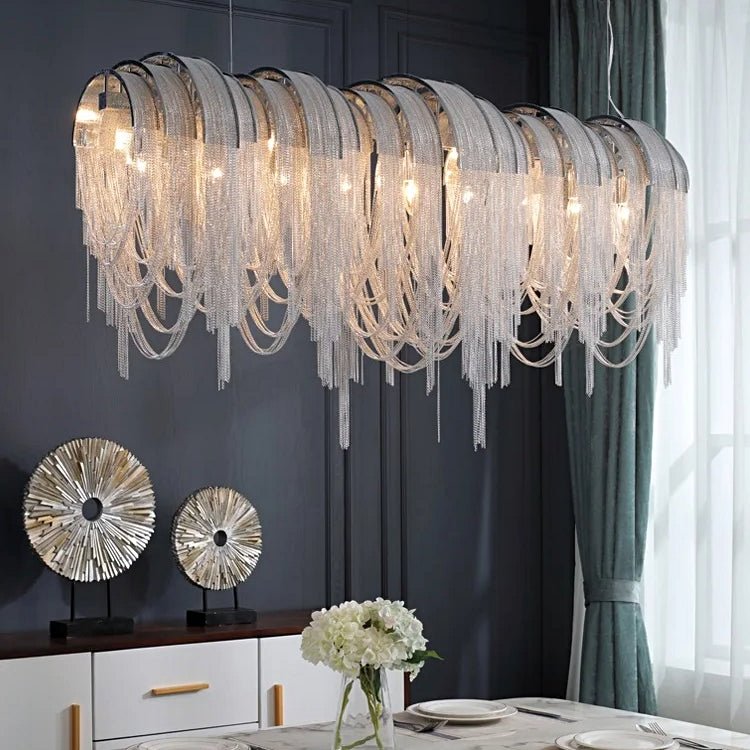 Cadena chain tassel dining room chandelier by Morsale.com, a 47-inch cascade of stainless steel and aluminum tassels above a dining table.