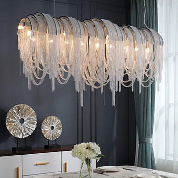 Cadena chain tassel dining room chandelier by Morsale.com, a 47-inch cascade of stainless steel and aluminum tassels above a dining table.