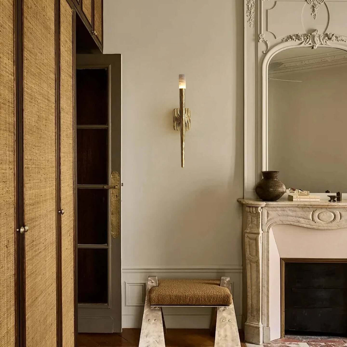 Valen wall sconce with glowing marble shade on forged brass