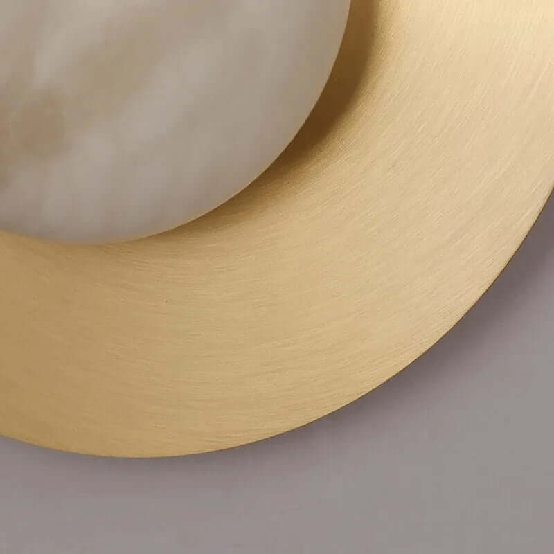 Calla brass and marble wall sconce in a hallway