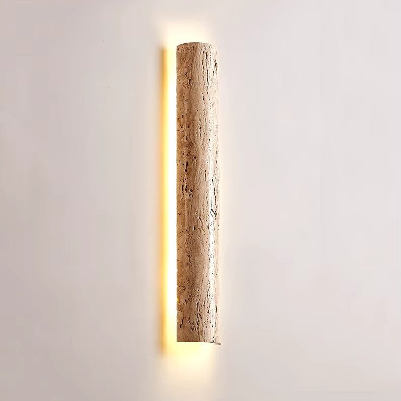 Detail of honey-toned travertine texture on the Solterra sconce
