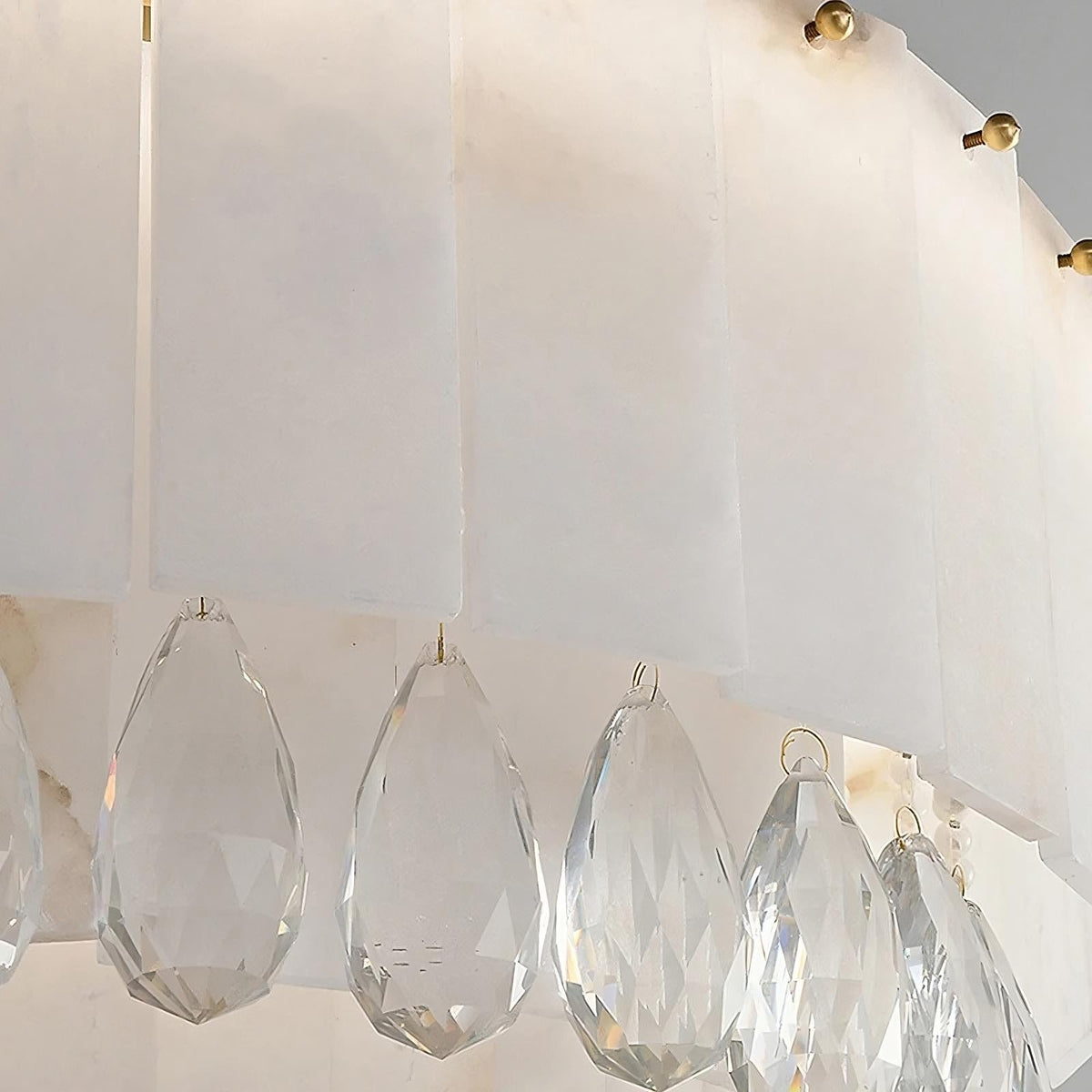 Stuart marble and crystal round chandelier over a dining table
