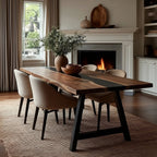 Dining room with a wooden table and chairs in front of a fireplace.