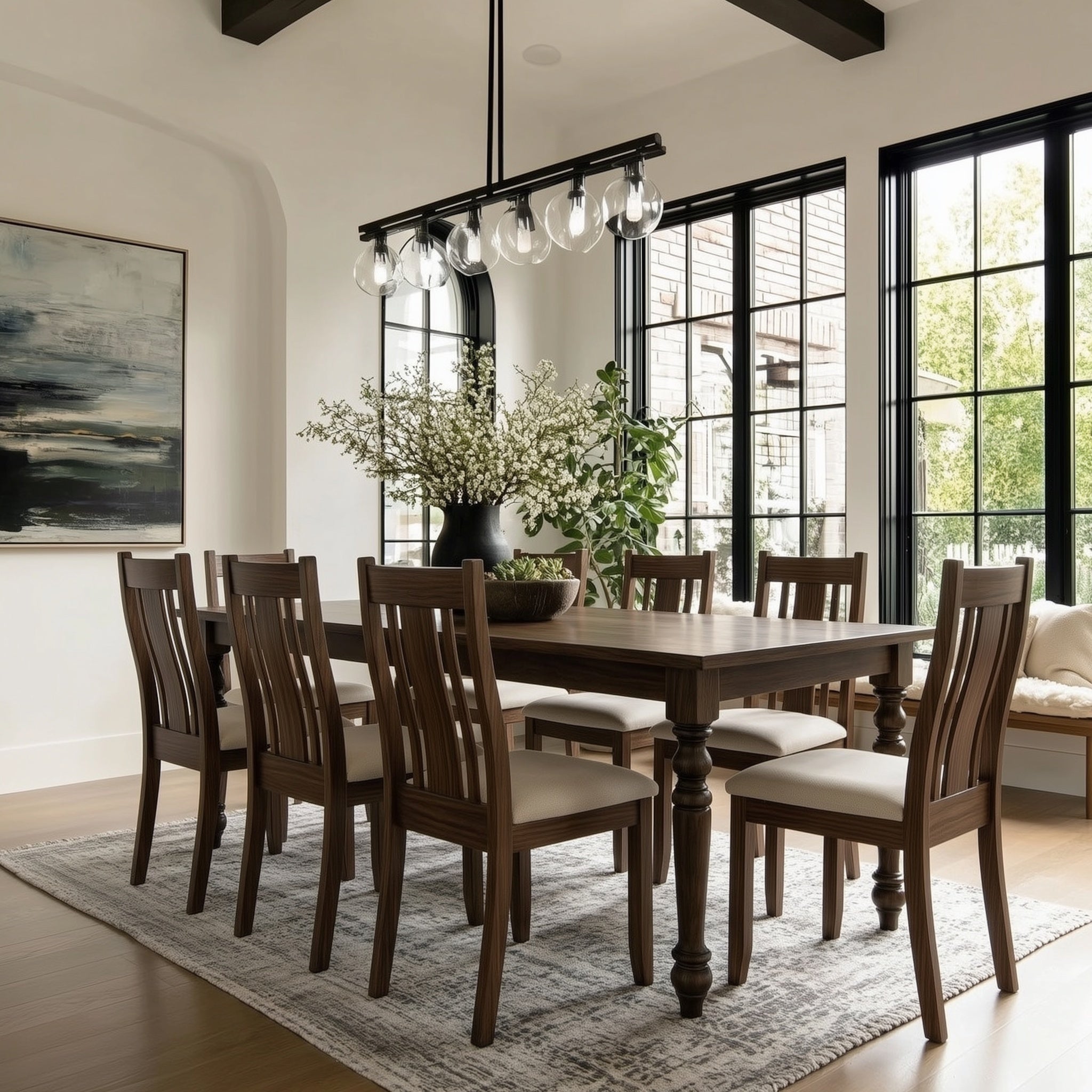 Dining room with wooden table and chairs, large windows, and decorative elements.