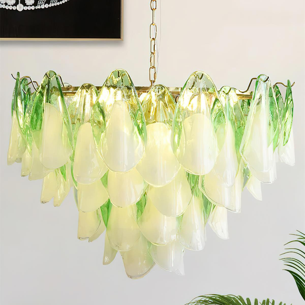 Chandelier with green and white glass shades on a light background