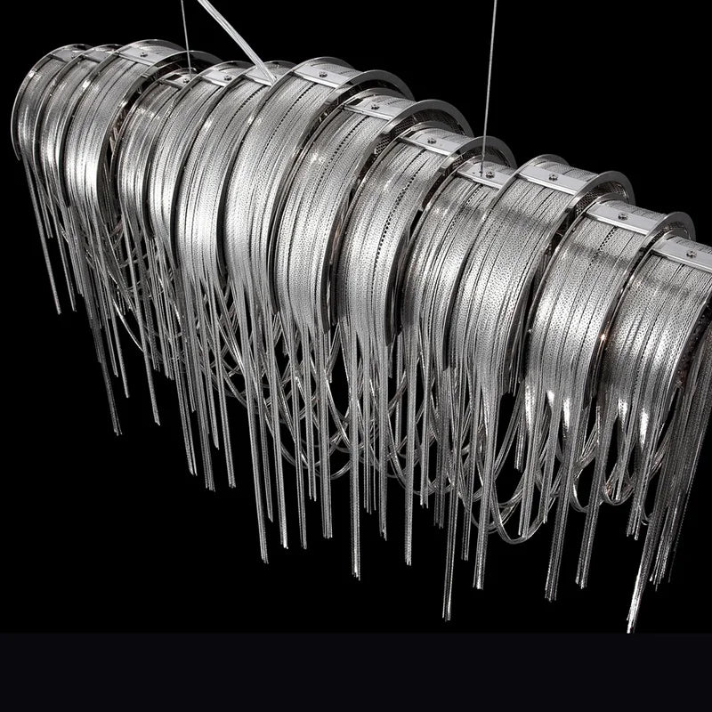 The Cadena dining chandelier by Morsale.com in a dining room, polished stainless steel and aluminum tassels.