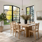 Dining room with wooden table and chairs, vase with flowers on the table.