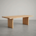 Wooden dining table on a gray floor with a neutral background