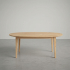 Wooden dining table on a plain gray background