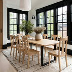 Dining room with wooden table and chairs, large windows, and decorative elements.