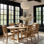 Dining room with wooden table and chairs, large windows, and decorative vase with flowers.