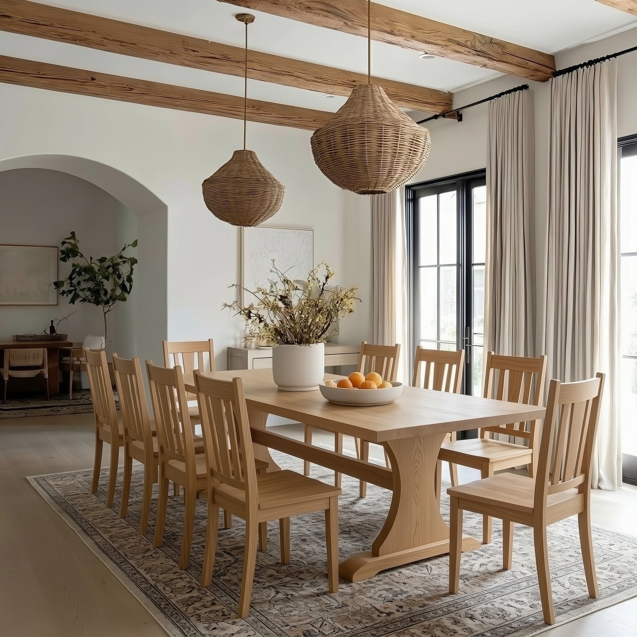 Dining room with wooden table and chairs, wicker pendant lights, and large windows.