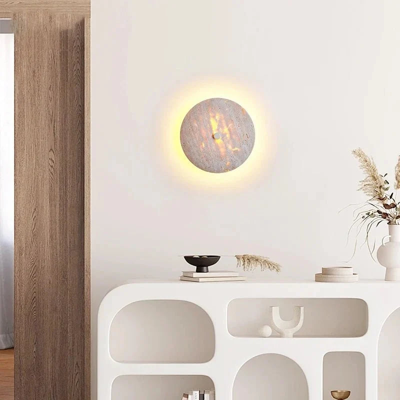 Brighton travertine sconce with warm glowing shade