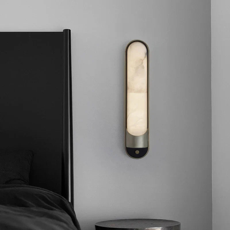 Sandford sconce casting up and down light on a wall