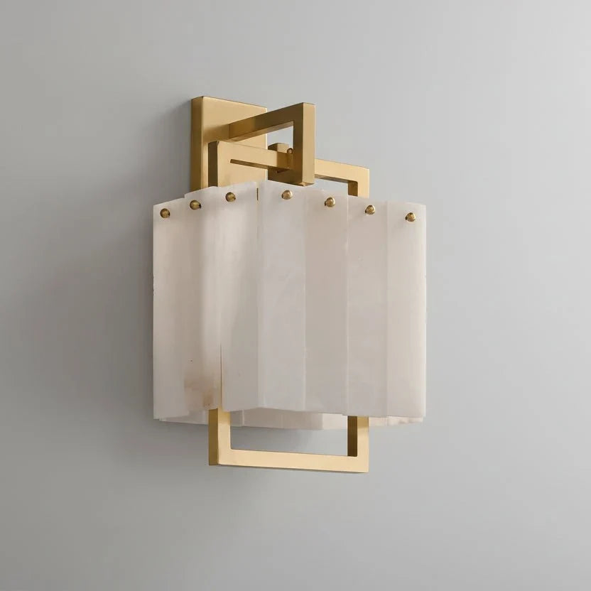 Stuart marble and brass wall sconce mounted on a wall