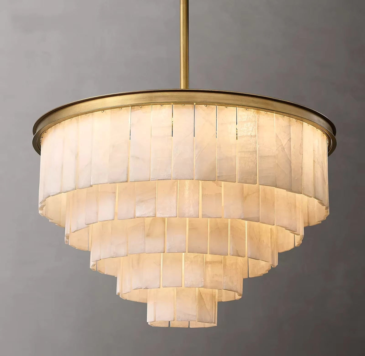 Berkley marble chandelier glowing warm in a living room