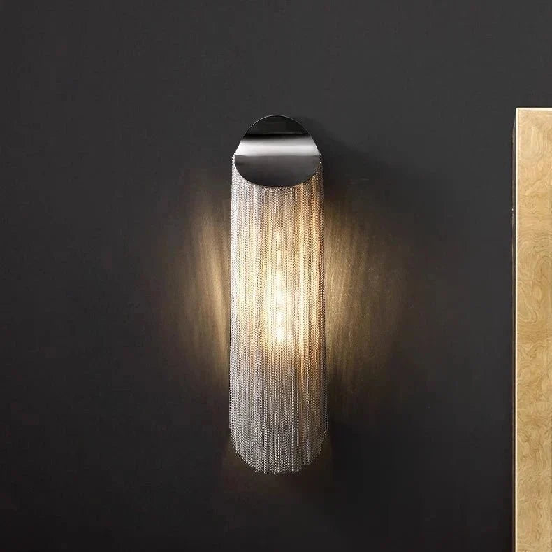 Detail of aluminum chain fringe on the Cadena tassel wall sconce