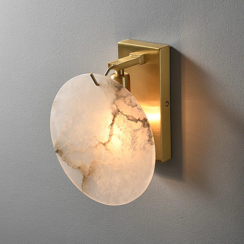 Auralis marble sconce with glowing natural stone shade