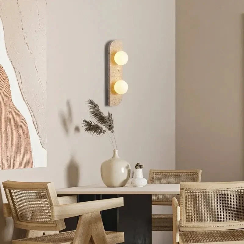 Sonte travertine sconce with warm glowing stone shade