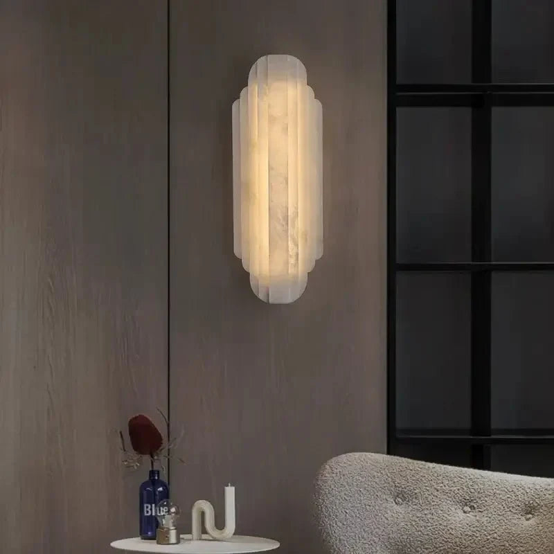 Arina marble wall sconce with glowing natural stone shade