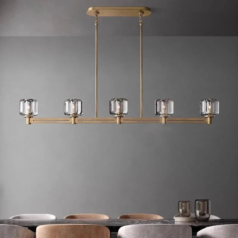 Ventoux linear crystal and brass chandelier over a dining table