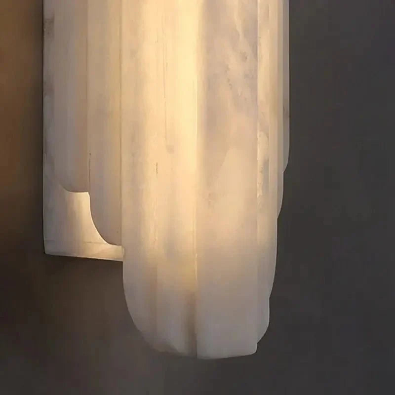 Arina marble sconce warm glow detail