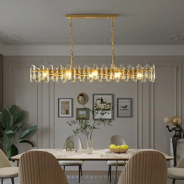 Marini 59-inch linear crystal chandelier over a long dining table