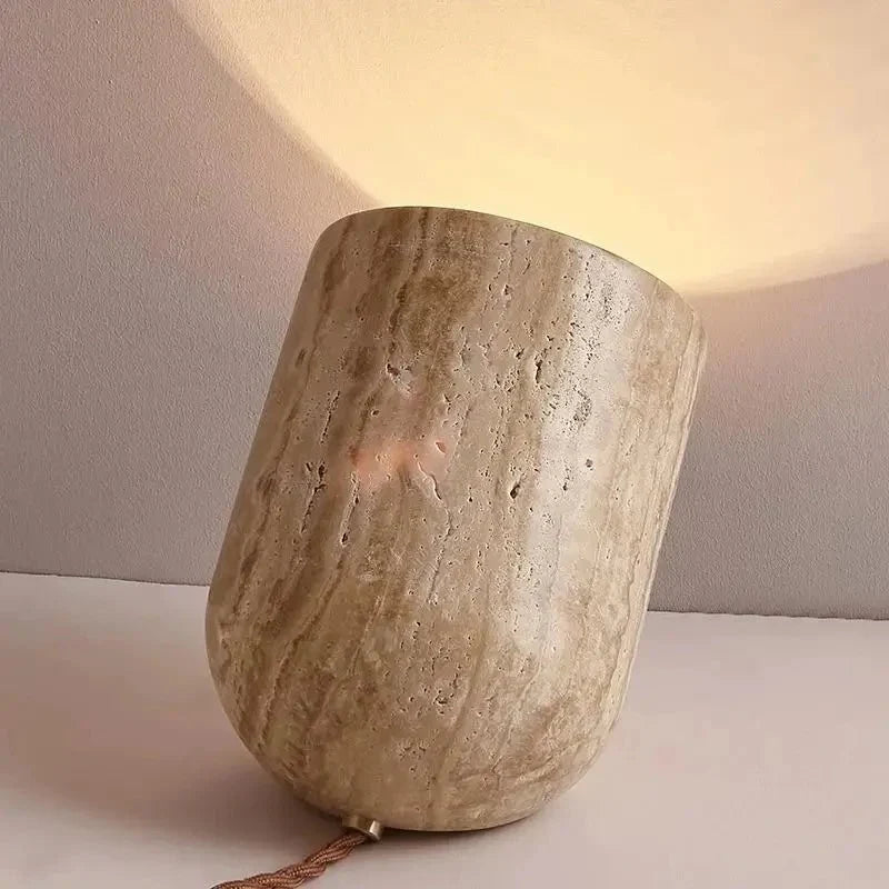 Modern travertine table lamp on a nightstand