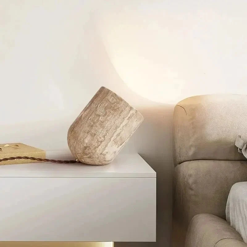 Solid natural travertine table lamp lit from within