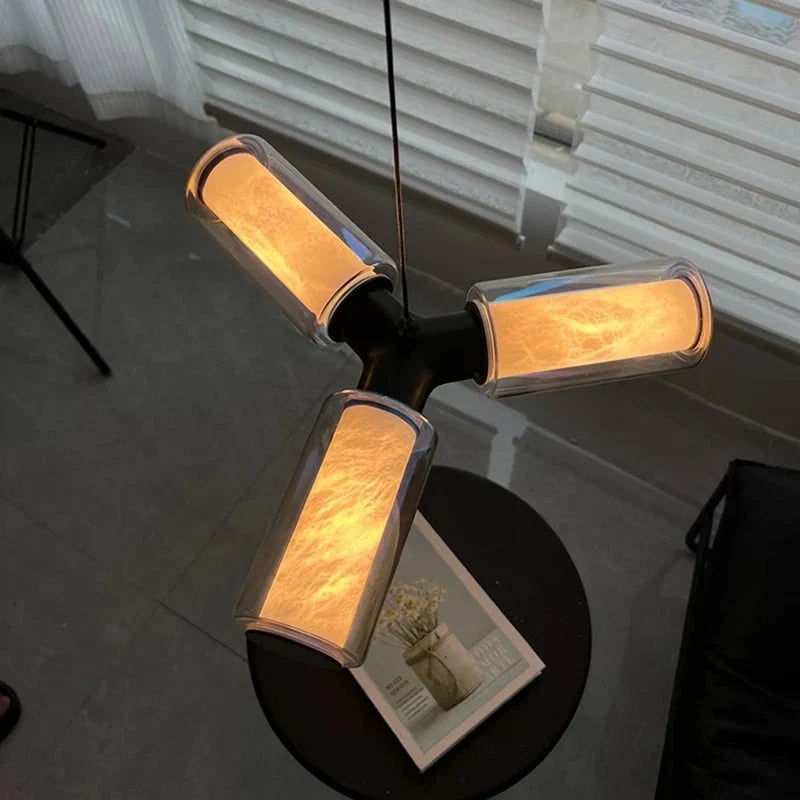 Lumiere pendant illuminated over a kitchen island