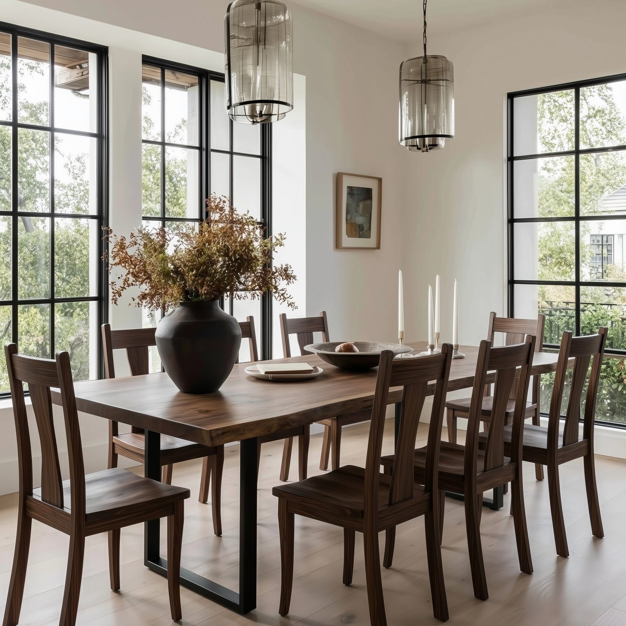 Dining room with wooden table and chairs, large windows, and decorative elements.