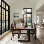 Dining room with wooden table and chairs near large windows