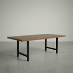 Wooden table with black metal legs on a gray floor and background