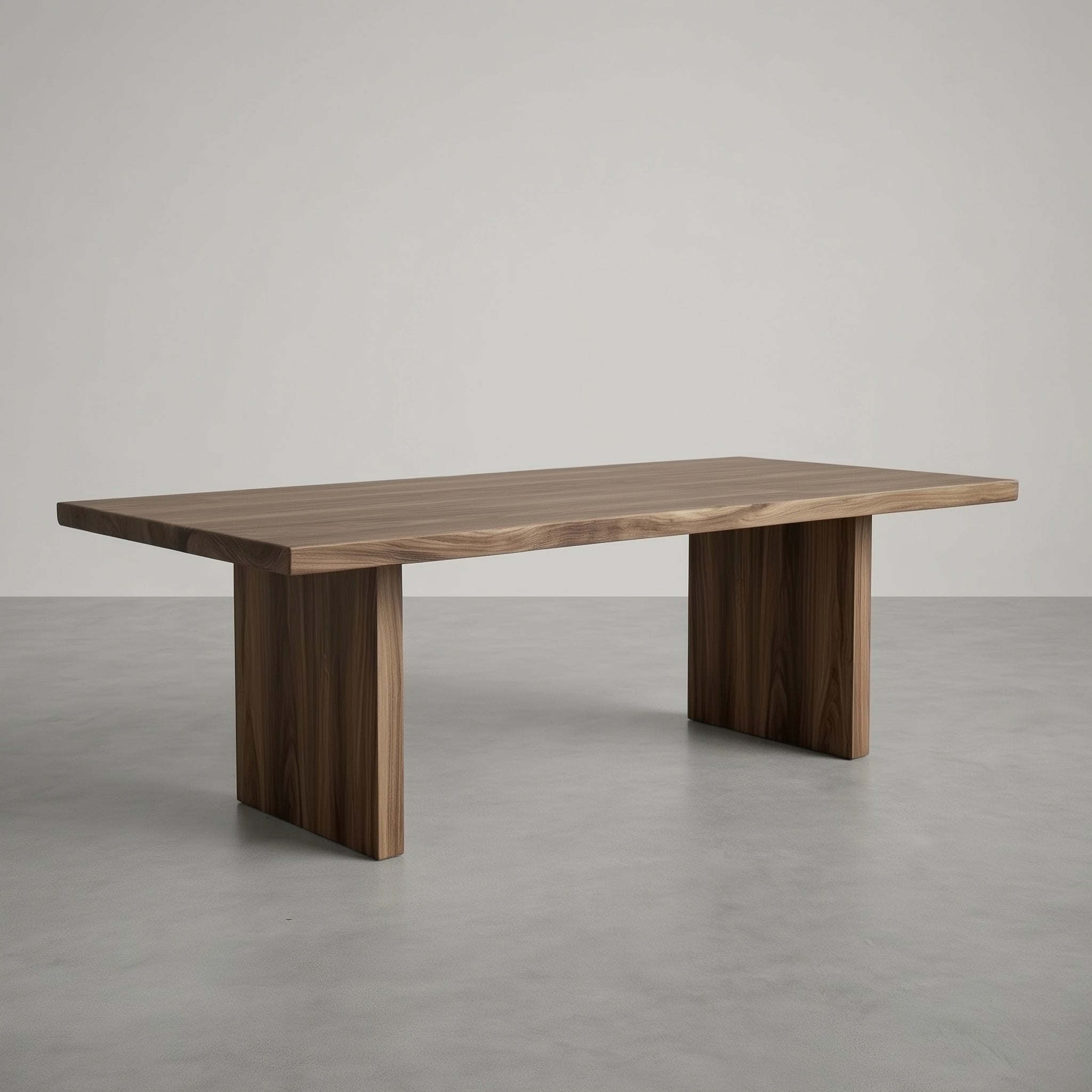 Wooden dining table on a gray floor with a neutral background