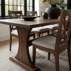 Dining room with wooden table and chairs in a well-lit room.