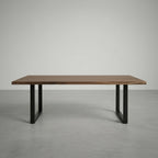 Wooden table with black metal legs on a gray background