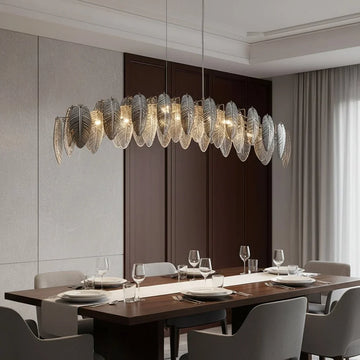 Giatti modern glass dining chandelier in gold over a table