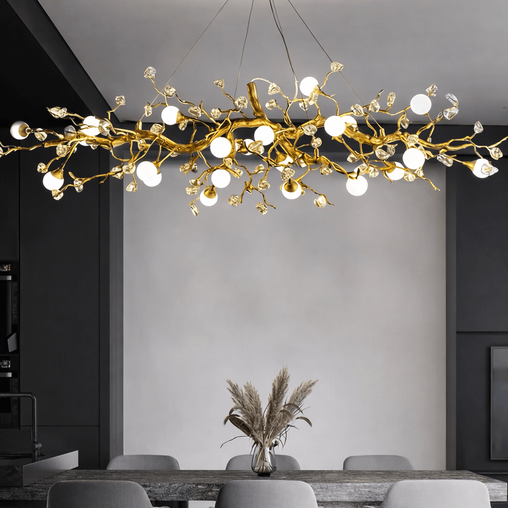 Albero sculptural gold branch chandelier over a dining table