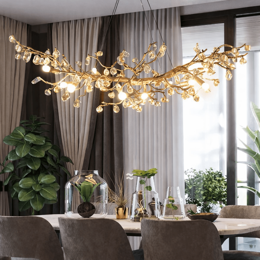 Albero gold branch crystal linear chandelier over a dining table