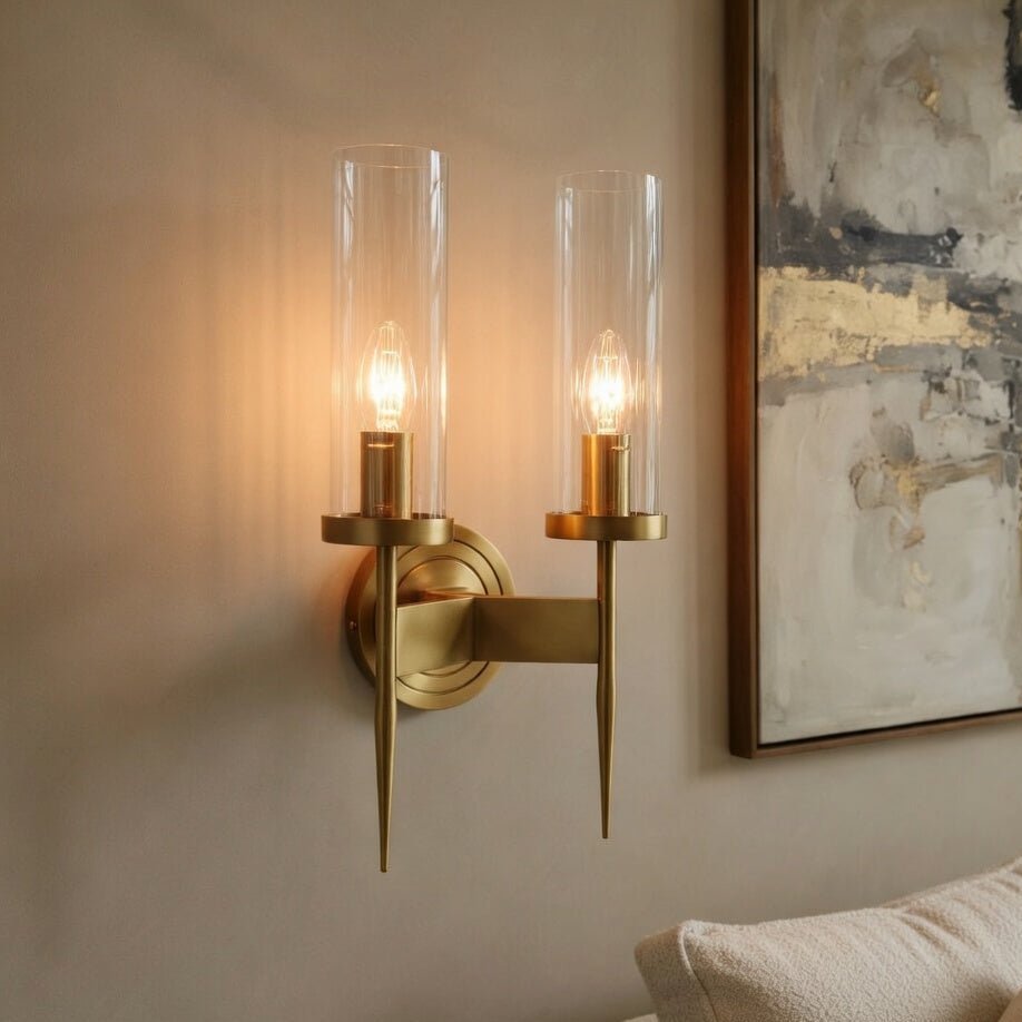 Palermo brass wall sconce illuminated with a warm glow