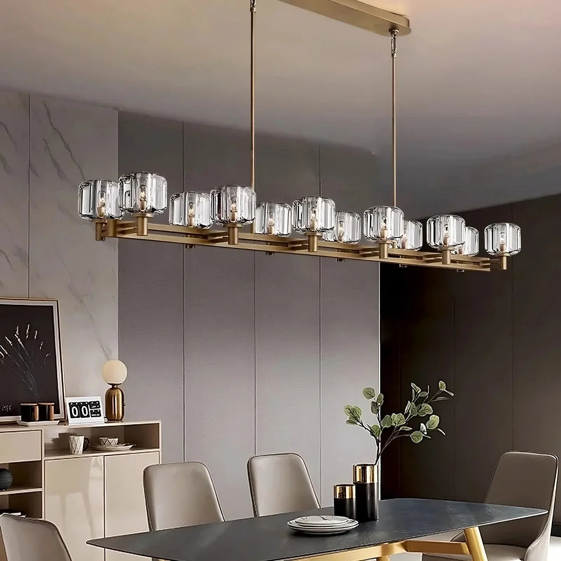 Ventoux linear crystal and brass chandelier over a dining table