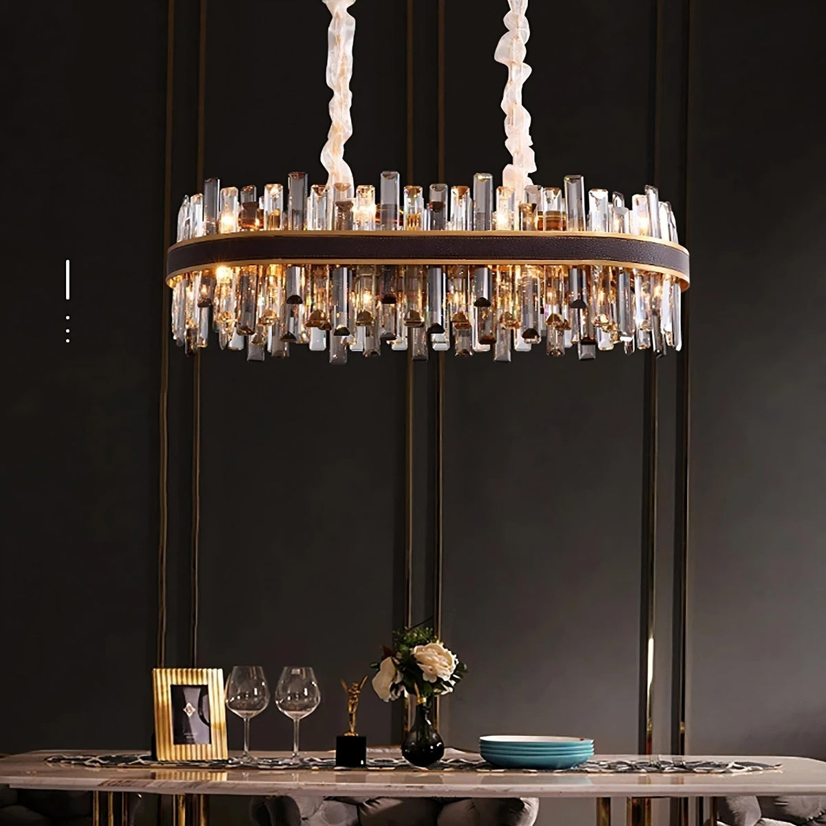 Calvi crystal dining chandelier on polished steel over a table