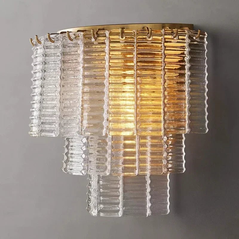 Sculptural glass shade with crystal accents on a brushed steel sconce