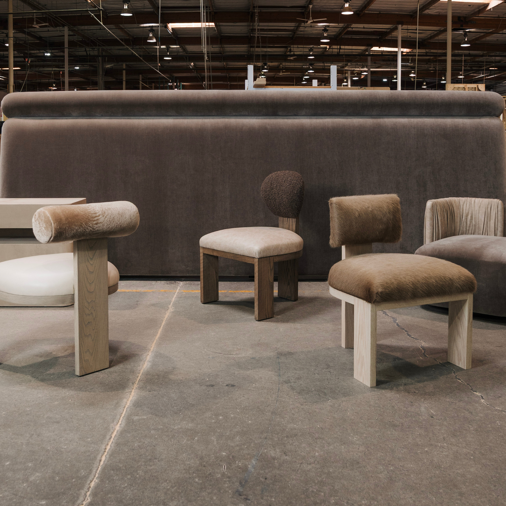 Modern furniture set including chairs and ottomans in a warehouse setting